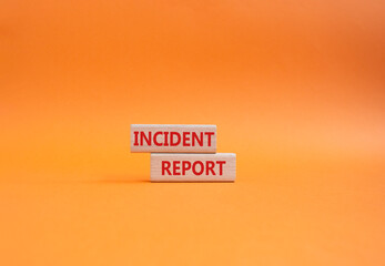 Incident Report symbol. Concept word Incident Report on wooden blocks. Beautiful orange background....