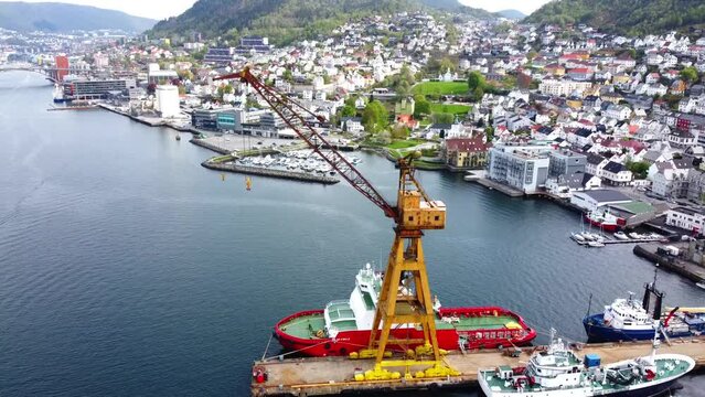 Overview Bergen Harbor with Old Yellow Crane and Neighborhood - Norway 2.7K Aerial Footage