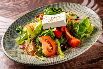 greek salad with cheese, tomato, olive, pepper, onion