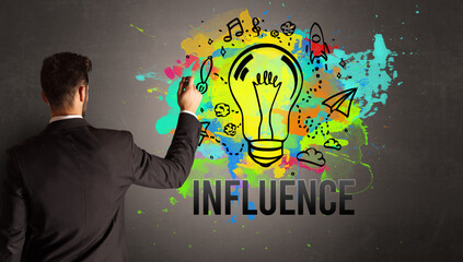 businessman drawing colorful light bulb