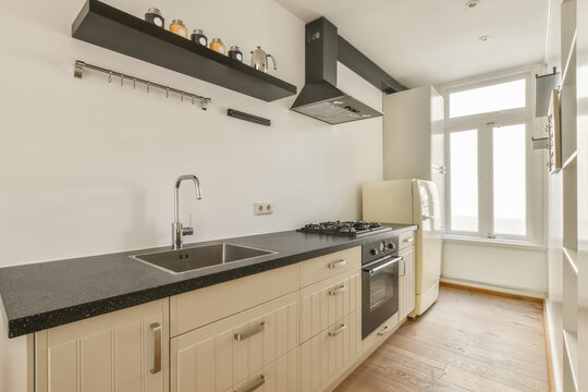 Kitchen with sink and rangehood and refrigerator