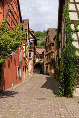Fototapeta na wymiar Half-timbered houses in a typical side street of Kaysersberg in Alsace, France