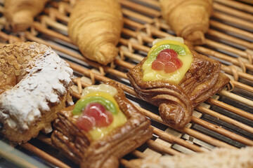 Closeup of bakery assortment of pastry, focus on puff with fruit filling