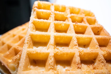 freshly baked Belgian waffles are piled up