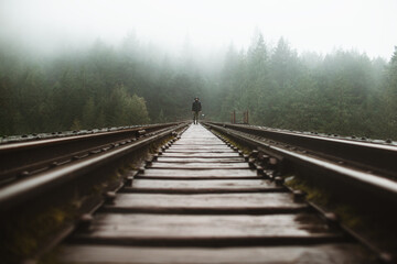 Man in misty railroad journey on Vancouver Island