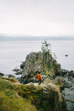 Woman in tranquil moment overlooking the sea of East Sooke Regional Park, Vancouver Island