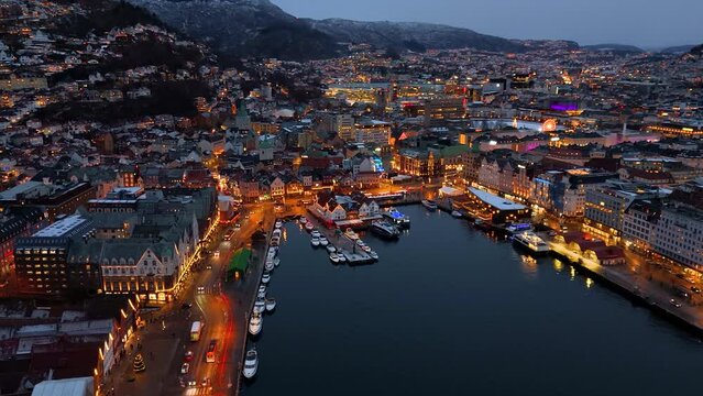 Panoramic aerial view of the city of Bergen, Bergenhus center district, Norway, during winter dusk time with snow and lights