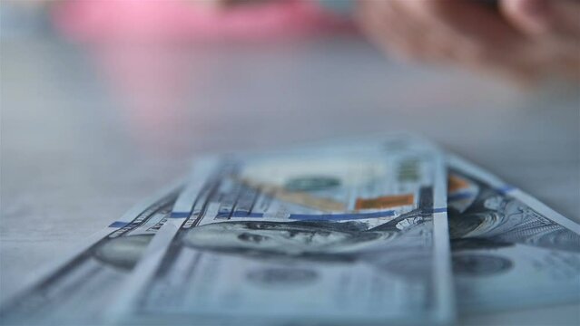 Woman Hands Counting 100 Dollar Banknotes On Table. Business Profit And Financial Success Concept. Slow Motion Effect.