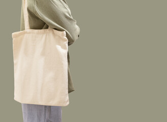 Carrying modern trendy eco tote bag on shoulder. Woman with shopper, green sustainable banner