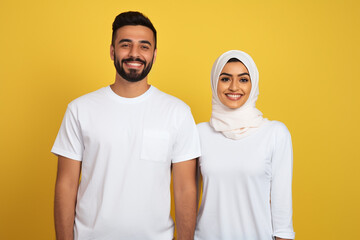 

Stock photography portrait of an arab couple smiling candidly, wearing a plain white shirt, isolated on a plain yellow colored background