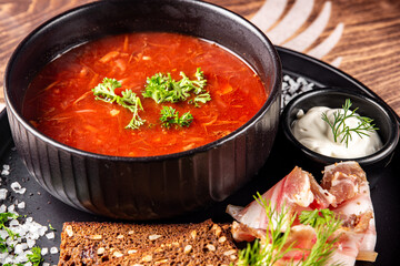 Beetroot soup Traditional Ukrainian or Russian borscht with sour cream in a bowl on wooden table