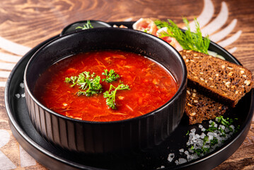 Beetroot soup Traditional Ukrainian or Russian borscht with sour cream in a bowl on wooden table