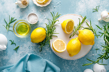 Lemon, rosemary, garlic, salt and olive oil. Ingredients for mediterranean cuisine cooking. Top view