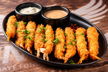 crispy shrimp tempura with garlic sauce on plate