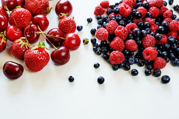 Berries dropped on the white surface.
