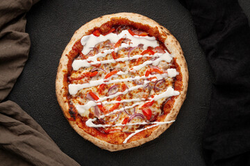 Pizza with bell peppers, onions, cheese and sauce
