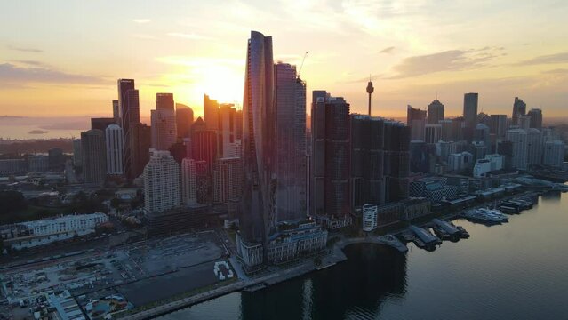 Aerial drone descending view of Barangaroo waterfront precinct in Sydney City, NSW Australia during a morning sunrise in December 2023     