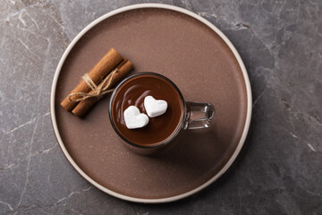 Top view on a cup of hot chocolate with marshmallows on a dark table.