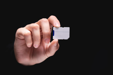 Micro SD memory card adapter on background. front view close up adapter in hand