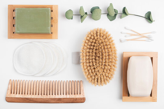 Zero waste beauty products, sustainable bathroom and eco-friendly lifestyle. Organic soap in wooden dish, cotton make-up pads and ears swabs, wood body brush and hair comb.