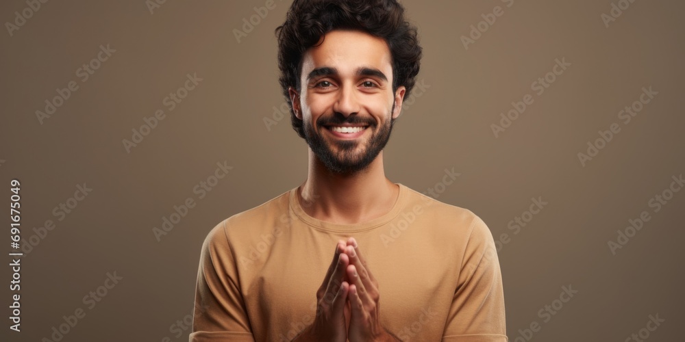 Poster A man with a beard is smiling and holding his hands together. This picture can be used to convey happiness, contentment, and positivity. It is suitable for various contexts and applications