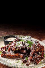 Deep fried rye croutons with grated parmesan cheese and sauce