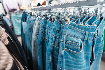 Stylish Blue Jeans Displayed on a Hanger in a Fashion Boutique Setting