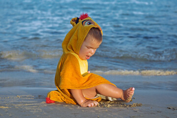 Small cute baby playing on the beach.Happy child on vacation with beautiful sea and sand  on the beach.Happy lifestyle childhood concept. - 691680050