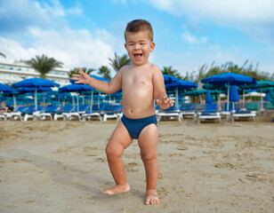 Small cute baby playing on the beach.Child in nature with beautiful sea, sand and blue sky.Happy child on vacation at sea running in the beach.Happy lifestyle childhood concept,Cyprus, Ayia-napa - 691680091