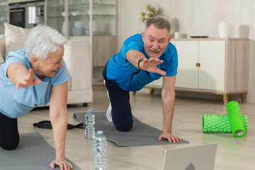 Fitness workout training. Senior adult mature healthy fit couple doing sports exercise on yoga mat...