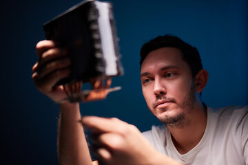 Cropped image of an engineer showing a computer microchip on the foreground
