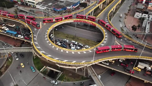 Aerial drone shot of Roundabouts in Bogota, Colombia, Latin America. Traffic in Bogota, Transmilenio. Dedicated busway on the top level. Famous roundabout full of red buses. High quality 4k footage.