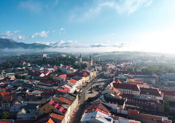 Panoramic aerial cityscape of Banská Bystrica old town, travel destination city in central Slovakia, located on the Hron River in a long and wide valley encircled by the mountain chains