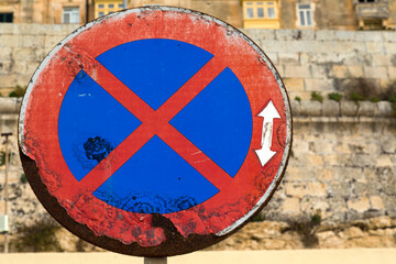 Old rusty no stopping traffic sign
