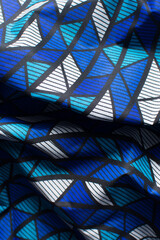 top view of blue and white ankara fabric, flatlay of nigerian wax cloth, rumpled blue and white...