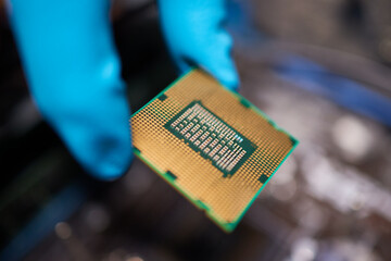 Cropped image of an engineer showing a computer microchip on the foreground