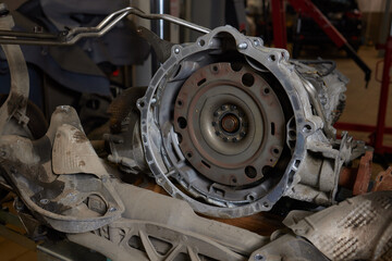 Closeup disassembled car automatic transmission gear part on workbench at garage or repair factory...
