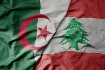 big waving national colorful flag of lebanon and national flag of algeria .