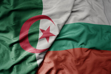 big waving national colorful flag of bulgaria and national flag of algeria .