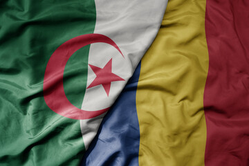 big waving national colorful flag of romania and national flag of algeria .
