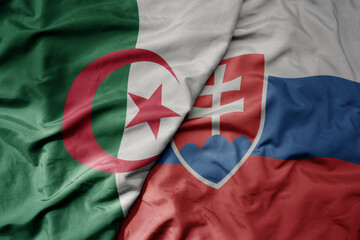 big waving national colorful flag of slovakia and national flag of algeria .
