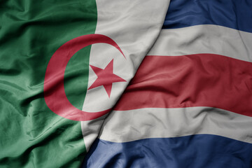 big waving national colorful flag of costa rica and national flag of algeria .