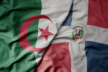 big waving national colorful flag of dominican republic and national flag of algeria .