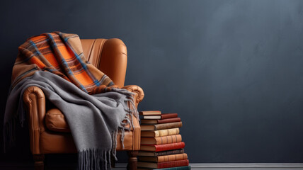 A cozy leather armchair draped with a plaid blanket next to a stack of books - obrazy, fototapety, plakaty