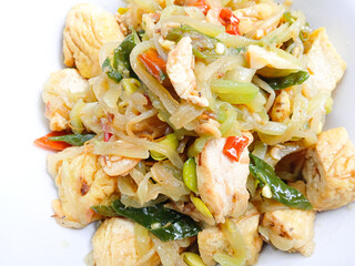 stir-fry chayote mixed with tofu and bean sprouts. Indonesia traditional food. Sayur welok atau labu siam dan tahu. spicy chayote cooked with tofu and bean sprouts in bowl on gray background. homemade