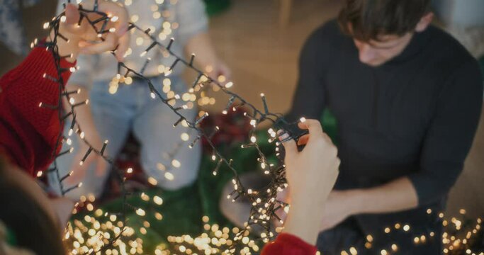 Friends with tangled glowing lights for decoration