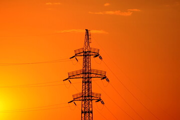 High voltage electricity line in Ukraine On Sunset. Concept of Russian missile attack on Ukrainian...