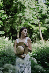portrait of a woman in white dress in the forest