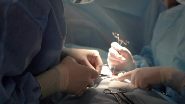 Doctors in a medical clinic perform a medical operation on a patient, operating room with instruments and medicines. Treating epidemics and diseases