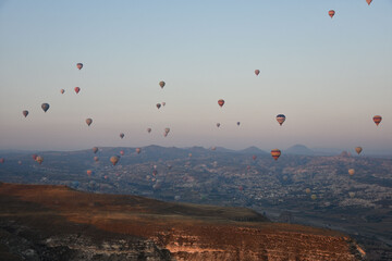 Hot air balloons in the sky over Goreme in Cappadocia, Turkey on a sunsrise